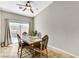 Cozy dining area with backyard access, featuring a ceiling fan, table, and tile floors at 6057 Leaping Foal St, North Las Vegas, NV 89081