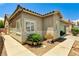 A well-kept exterior with desert landscaping and a concrete walkway leading to the front at 6057 Leaping Foal St, North Las Vegas, NV 89081