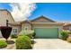 Charming single-story home with desert landscaping and a two-car green garage door at 6057 Leaping Foal St, North Las Vegas, NV 89081