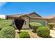 Single-story home featuring lush landscaping, a well-maintained lawn, and desert rock accents at 6057 Leaping Foal St, North Las Vegas, NV 89081