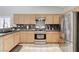 Spacious kitchen featuring stainless steel appliances, granite countertops, and wooden cabinets at 6057 Leaping Foal St, North Las Vegas, NV 89081