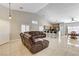Open layout living room with tile floors, modern furnishings, and abundant natural light at 6057 Leaping Foal St, North Las Vegas, NV 89081