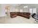A spacious living room featuring a large sectional sofa and tiled flooring throughout at 6057 Leaping Foal St, North Las Vegas, NV 89081