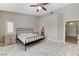 Main bedroom with a ceiling fan, ensuite bathroom, and tiled floor at 6057 Leaping Foal St, North Las Vegas, NV 89081