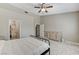 Main bedroom with a ceiling fan, ensuite bathroom, and tiled floor at 6057 Leaping Foal St, North Las Vegas, NV 89081