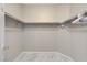Walk-in closet with shelving and tiled floor for organized storage at 6057 Leaping Foal St, North Las Vegas, NV 89081