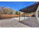 This backyard has a covered patio, gravel landscaping, and built in grill at 9321 Dancing Daffodil Ave, Las Vegas, NV 89129