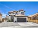 Exterior view of home with a large driveway, garage, and mature landscaping at 9321 Dancing Daffodil Ave, Las Vegas, NV 89129