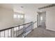 Upstairs hallway with carpet, black railings, large windows and natural light at 9321 Dancing Daffodil Ave, Las Vegas, NV 89129