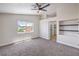 Bright main bedroom features carpet, a ceiling fan, and an attached bathroom at 9321 Dancing Daffodil Ave, Las Vegas, NV 89129