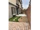 Backyard featuring a stone patio, artificial grass, and a rock garden at 10450 Badger Ravine St, Las Vegas, NV 89178