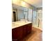 Bathroom with double sink vanity, a walk-in shower, and a soaking tub at 10450 Badger Ravine St, Las Vegas, NV 89178