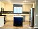 Well-lit kitchen featuring a center island, modern appliances, and ample cabinet space at 10450 Badger Ravine St, Las Vegas, NV 89178