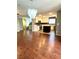 Open-concept kitchen with stainless steel appliances, center island, and hardwood floors at 10450 Badger Ravine St, Las Vegas, NV 89178