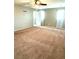 Spacious living room with neutral walls, ample natural light, and ceiling fan at 10450 Badger Ravine St, Las Vegas, NV 89178