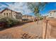 Community area between properties features gravel, walls, trees, and drought resistant landscaping at 1161 Gecko Rd, Henderson, NV 89002