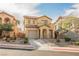 Charming two-story home featuring a desert landscape, neutral stucco exterior and attached garage at 1161 Gecko Rd, Henderson, NV 89002