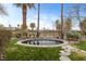 Backyard with spa, lush landscaping, palm trees, and stone walkway at 2822 Soft Horizon Way, Las Vegas, NV 89135