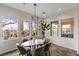 Bright dining area with backyard views, modern chandelier, and comfortable seating at 2822 Soft Horizon Way, Las Vegas, NV 89135