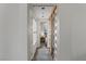 Hallway with decorative tile floors, barn door and view into bedroom at 2822 Soft Horizon Way, Las Vegas, NV 89135