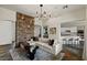 Spacious living room featuring a stone accent wall and an open layout to the gourmet kitchen at 2822 Soft Horizon Way, Las Vegas, NV 89135