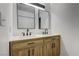 Bathroom featuring a double sink vanity with stylish wood cabinets and modern fixtures at 3008 Saint George St # F, North Las Vegas, NV 89030
