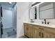 Bathroom featuring a double sink vanity with wood cabinets and modern fixtures at 3008 Saint George St # F, North Las Vegas, NV 89030