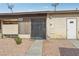 Exterior view of the house with a fenced entrance and gravel landscaping at 3008 Saint George St # F, North Las Vegas, NV 89030