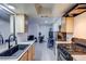 Modern kitchen sink with sleek black faucet overlooking an adjacent living space at 3008 Saint George St # F, North Las Vegas, NV 89030