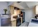 Compact kitchen featuring stainless steel appliances and light wood cabinets at 3008 Saint George St # F, North Las Vegas, NV 89030