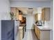 Efficient kitchen featuring stainless steel appliances and light wood cabinets at 3008 Saint George St # F, North Las Vegas, NV 89030