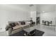 Spacious living room with a large sofa, desk area, and sleek black coffee table at 3008 Saint George St # F, North Las Vegas, NV 89030