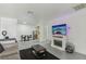 Bright living room with a fireplace, a large sofa, and a view into the adjacent kitchen at 3008 Saint George St # F, North Las Vegas, NV 89030