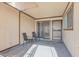 Relaxing patio with chairs and sliding door to the interior at 3008 Saint George St # F, North Las Vegas, NV 89030
