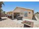 Residential backyard features a fire pit, covered patio and landscaped area at 5580 Lonesome Biker Ln, Las Vegas, NV 89113