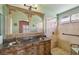Elegant bathroom featuring a dual sink vanity, ornate mirror, and a walk-in shower at 5580 Lonesome Biker Ln, Las Vegas, NV 89113
