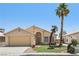 Charming single-story home featuring a two-car garage, desert landscaping and mature palm trees at 5580 Lonesome Biker Ln, Las Vegas, NV 89113