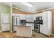 Bright kitchen with stainless steel appliances, granite counters, kitchen island and hardwood floors at 5580 Lonesome Biker Ln, Las Vegas, NV 89113