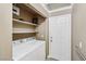 Functional laundry room with white appliances and ample shelving at 5580 Lonesome Biker Ln, Las Vegas, NV 89113