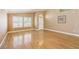Bright living room featuring hardwood floors, neutral paint, and large windows with shutters at 5580 Lonesome Biker Ln, Las Vegas, NV 89113