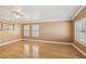 Spacious living room with hardwood floors, neutral paint, and large windows with shutters at 5580 Lonesome Biker Ln, Las Vegas, NV 89113