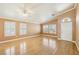 Bright living room featuring hardwood floors, neutral paint, and large windows with shutters at 5580 Lonesome Biker Ln, Las Vegas, NV 89113