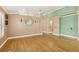 Open living room featuring hardwood floors, decorative mirror and art niche at 5580 Lonesome Biker Ln, Las Vegas, NV 89113