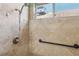 Tiled shower with grab bar, hand held shower wand and clerestory window at 5580 Lonesome Biker Ln, Las Vegas, NV 89113