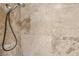 Tiled shower featuring a handheld shower head and neutral stone-look tile at 5580 Lonesome Biker Ln, Las Vegas, NV 89113
