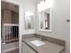 Bathroom featuring a mirror above the sink with granite-look countertop at 9836 Russett Wood Cir, Las Vegas, NV 89117