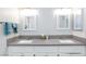 Modern bathroom with double sinks and gray countertops at 9836 Russett Wood Cir, Las Vegas, NV 89117