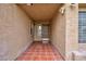Inviting front porch featuring stylish tile flooring and a warm, neutral color scheme at 9836 Russett Wood Cir, Las Vegas, NV 89117