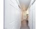 Hallway with large closet doors, leading to a bright bathroom with a shower and vanity at 9836 Russett Wood Cir, Las Vegas, NV 89117