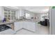 Bright kitchen with white cabinets, tile floors, and modern appliances, offering a clean design at 9836 Russett Wood Cir, Las Vegas, NV 89117